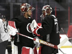 Ottawa Senators goaltender Cam Talbot (33) taps goaltender Kevin Mandolese (70) with his stick as they greet each other during the team's training camp in Ottawa, on September 22, 2022.