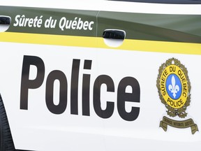 A Surete du Quebec police car is seen in Montreal on July 22, 2020.&ampnbsp;Quebec provincial police say they have arrested a 53-year-old man in connection with a shooting at an upscale resort in the Laurentians region.