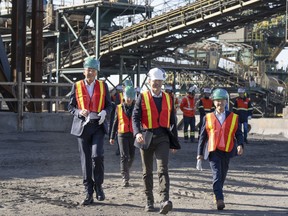 Prime Minister Justin Trudeau arrives with Rio Tinto chief executive Jakob Sausholm, left, and Industry Minister Francois-Philippe Champagne, right, for a tour of the new pilot project for a blue smelting facility at the Rio Tinto plant on Oct. 11, 2022 in Sorel, Que.