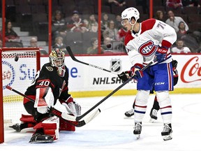 Montreal Canadiens centre Jake Evans (71) watches as the puck goes in the net after his backhand, for his second goal of the game against Ottawa Senators goaltender Mads Sogaard (40), during first period NHL pre-season hockey action in Ottawa, on Saturday, Oct. 1, 2022.