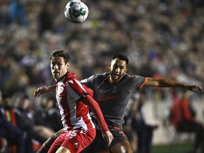 Atletico Ottawa's Sergio Camus Perojo (5) and Forge FC's David Choinière (7) battle for the ball during first half Canadian Premier League finals soccer action in Ottawa on Sunday, Oct. 30, 2022.