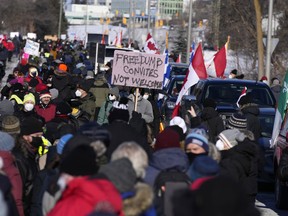Local residents participate in a counter protest, preventing vehicles from driving in a convoy en route to Parliament Hill, in Ottawa, Sunday, Feb. 13, 2022. The inquiry into the federal government's use of the Emergencies Act is expected to hear first-hand testimony about the impact February's Freedom Convoy protest had on the people and business in downtown Ottawa.