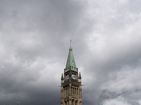 Storm clouds pass by the Peace tower and Parliament Hill Tuesday August 18, 2020 in Ottawa.&ampnbsp;Annual financial statements show the federal deficit for the previous fiscal year was $23.6 billion lower than the projected in the spring budget.&ampnbsp;THE CANADIAN PRESS/Adrian Wyld
