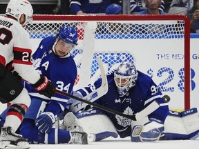 Toronto Maple Leafs goaltender Ilya Samsonov (35) makes a save on Ottawa Senators' Claude Giroux (28) with help from Auston Matthews (34) during second period NHL hockey action in Toronto on Saturday, October 15, 2022.