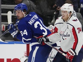 Toronto Maple Leafs' Auston Matthews (34) and Washington Capitals' John Carlson (74) battle during third period NHL hockey action in Toronto on Thursday, October 13, 2022.