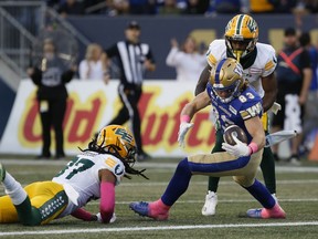 Winnipeg Blue Bombers' Dalton Schoen (83) catches the touchdown pass from quarterback Zach Collaros (8) and crosses the line for the score against the Edmonton Elks during first half CFL action in Winnipeg Saturday, October 8, 2022.