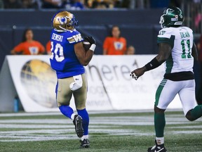 Winnipeg Blue Bombers' Nic Demski (10) catches a touchdown pass as Saskatchewan Roughriders' Larry Dean (11) looks on during second half CFL action in Winnipeg Friday, September 30, 2022. Quarterback Zach Collaros and receiver Demski of the Winnipeg Blue Bombers and Calgary Stampeders linebacker Jameer Thurman were named the CFL's top performers for September on Wednesday.THE CANADIAN PRESS/John Woods
