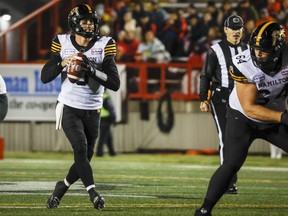 Hamilton Tiger-Cats quarterback Dane Evans looks for a receiver during first half CFL football action against the Calgary Stampeders in Calgary, Friday, Oct. 14, 2022.THE CANADIAN PRESS/Jeff McIntosh