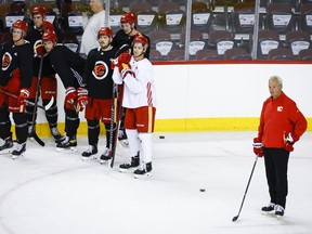Calgary Flames head coach Darryl Sutter, right, looks on during a training camp practice in Calgary, Alta., Thursday, Sept. 22, 2022.&ampnbsp;The Flames have signed head coach Darryl Sutter to a multi-year contract extension, the team announced Saturday.&ampnbsp;THE CANADIAN PRESS/Jeff McIntosh