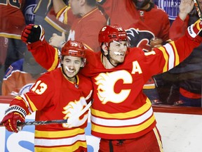 Calgary Flames forward Matthew Tkachuk, right, celebrates his goal with teammate forward Johnny Gaudreau during third period NHL second round playoff hockey action in Calgary, Alta., Wednesday, May 18, 2022.