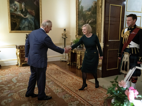 Britain's King Charles shakes hands with British Prime Minister Liz Truss during their weekly audience at Buckingham Palace in London, Britain, Oct. 12.