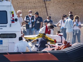 FILE - Bodies are disembarked on the tiny Sicilian island of Lampedusa, Italy, Oct. 21, 2022. More than 29,000 migrants have died trying to reach Europe since 2014, with 5,000 deaths in the last two years, the International Organization for Migration said in a report Tuesday Oct. 25, 2022.