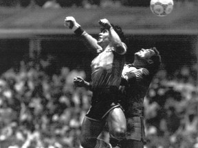 FILE - Argentina's Diego Maradona, left, beats England goalkeeper Peter Shilton to a high ball and scores his first of two goals in a World Cup quarterfinal soccer match, in Mexico City, on June 22, 1986. The ball used when Maradona scored his "Hand of God" goal against England at the 1986 World Cup has been put up for auction by the Tunisian referee who was in charge of the game. Graham Budd Auctions said Thursday Oct. 13, 2022 that they expect the 36-year-old Adidas ball, which referee Ali Bin Nasser owns, to fetch between $2.7 million and $3.3 million when it goes up for sale in Britain on Nov. 16, four days before the World Cup in Qatar kicks off. (AP Photo/El Grafico, File)