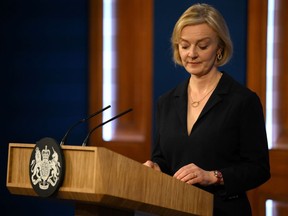Britain's Prime Minister Liz Truss holds a press conference in the Downing Street Briefing Room in central London, Friday Oct. 14, 2022. Embattled British Prime Minister sacked her Treasury chief and reversed course on sweeping tax cuts Friday as she tried to hang on to her job after weeks of turmoil on financial markets.