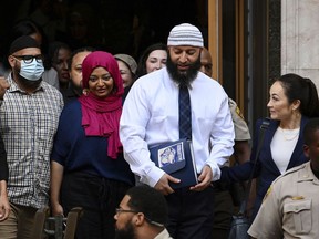 FILE - Adnan Syed, center right, leaves the courthouse after a hearing on Sept. 19, 2022, in Baltimore. Hae Min Lee's brother, Young Lee, has asked the Maryland Court of Special Appeals to halt court proceedings for Syed, whose conviction in Lee's 1999 killing was reversed by Baltimore Circuit Judge Melissa Phinn in September 2022. Now, the office of Maryland's attorney general is supporting the brother's appeal.