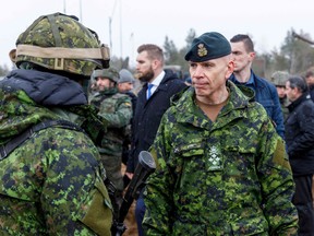 Chief of Defence Staff Gen. Wayne Eyre, right, talks with soldiers during a visit to the Adazi military base in Latvia, March 8, 2022.