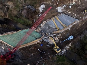 Responders gather at a bridge under construction after it collapsed in rural Clay County near Kearny, Mo., Wednesday, Oct. 26, 2022. Workers were pouring concrete on the bridge when the accident happened killing one worker and injuring two others.