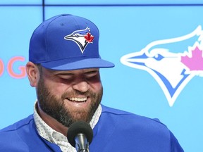 Toronto Blue Jays manager John Schneider smiles after being announced a three-year contract to remain as the team's manager during a press conference in Toronto on Friday, Oct. 21, 2022.