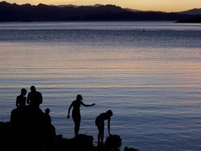FILE - In this May 27, 2011 file photo, kids fish at twilight at the edge of Kingman Wash, at Lake Mead National Recreation Area in Arizona. Regional health officials say a Las Vegas-area boy died from a rare brain-eating amoeba that investigators think he was exposed to in warm waters at Lake Mead.