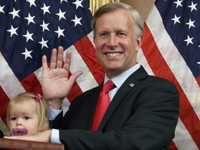 FILE - Congressman Chris Jacobs, R-N.Y., center, poses for a photo with his daughter Anna, 1, during a ceremonial swearing-in on Capitol Hill, July 21, 2020, in Washington. Jacobs is not seeking reelection amid backlash over his support for an assault weapons ban. But he's still advocating for regulation on his way out of Congress.