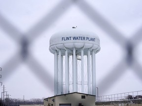 FILE - The Flint water plant tower is seen on Jan. 6, 2022, in Flint, Mich. A Michigan judge dismissed charges Tuesday, Oct. 4, 2022, against seven people in the Flint water scandal, including two former state health officials blamed for deaths from Legionnaires' disease. Judge Elizabeth Kelly took action three months after the Michigan Supreme Court said a one-judge grand jury had no authority to issue indictments.