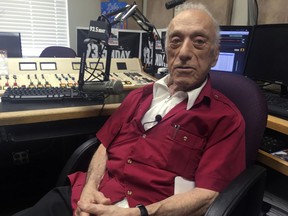 FILE - DJ Art Laboe sits in his studio and talks about his 75 years in the radio business on Oct. 9, 2018, in Palm Springs, Calif. Laboe, a pioneering disc jockey who hosted a syndicated oldies show for decades, died Friday, Oct. 7, 2022. Laboe is credited with helping end segregation in Southern California by organizing live DJ shows at drive-in eateries that attracted whites, Blacks and Latinos who danced to rock-n-roll. He was 97.
