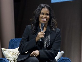 FILE - Former first lady Michelle Obama speaks to the crowd as she presents her anticipated memoir "Becoming" during her book tour stop in Washington, on Nov. 17, 2018. Obama plans a six-city tour this fall in support of her new book, "The Light We Carry: Overcoming in Uncertain Times," beginning mid-November in Washington. D.C. and ending a month later in Los Angeles.