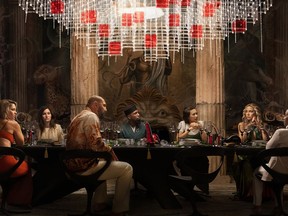 This image released by Netflix shows, from left, Edward Norton, Madelyn Cline, Kathryn Hahn, Dave Bautista, Leslie Odom Jr., Jessica Henwick, Kate Hudson, Janelle Monae, and Daniel Craig in a scene from "Glass Onion: A Knives Out Mystery." (Netflix via AP)