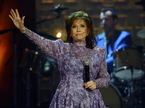 FILE - Loretta Lynn waves to the crowd after performing during the Americana Music Honors and Awards show Wednesday, Sept. 17, 2014, in Nashville, Tenn. Lynn, the Kentucky coal miner's daughter who became a pillar of country music, died Tuesday at her home in Hurricane Mills, Tenn. She was 90.