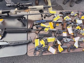 This photo, provided by the Office of New York Attorney General Letitia James, on Aug. 28, 2022 shows some of the 296 firearms, including 177 ghost guns, that were surrendered to law enforcement at a gun buy-back event hosted by her office and the Utica, NY, Police Department. The New York attorney general's office has tightened rules on gun buybacks after a critic of the policy boasted online about receiving $21,000 in gift cards for weapon parts made on a 3D printer. Buybacks are a popular way for government officials to try to get guns off the streets. But they can also attract people trying to demonstrate that buybacks are futile in the era of printable weapons. (Office of New York Attorney General via AP)