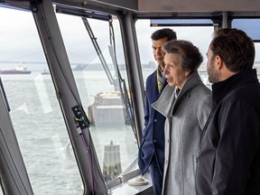 This photo, provided by the New York City Department of Transportation shows Britain's Princess Anne, accompanied by the agency's Commissioner Ydanis Rodriguez, left, as she rides in the pilothouse of the Staten Island Ferry "Sandy Ground," in New York Harbor, Tuesday, Oct. 4, 2022. The trip on a the commuter ferry came after the princess was given a tour of Staten Island's National Lighthouse Museum that included an an unveiling of a miniature figurine of Needles Lighthouse, in the Isle of Wight, in memory of her parents.