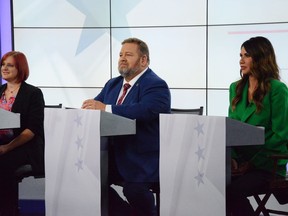 South Dakota Gov. Kristi Noem, right, Democratic challenger and state lawmaker Jamie Smith, center, and Libertarian candidate Tracey Quint meet in a debate hosted by KSFY-TV in Rapid City, S.D., Friday, Sept. 30, 2022. (KSFY-TV via AP)