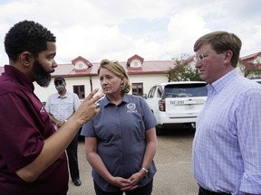 FILE - Deanne Criswell, administrator of the Federal Emergency Management Agency (FEMA), center, and Mississippi Gov. Tate Reeves, right, confer with Jackson Mayor Chokwe Antar Lumumba following a tour the City of Jackson's O.B. Curtis Water Treatment Facility in Ridgeland, Miss., Sept. 2, 2022. Jackson's water system partially failed following flooding and heavy rainfall that exacerbated longstanding problems in one of two water-treatment plants. On Friday, Oct. 28, Reeves extended the State of Emergency regarding Jackson's water system until Nov. 22.
