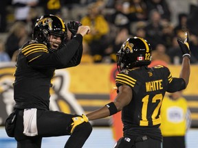 Hamilton Tiger-Cats quarterback Dane Evans (9) celebrates his touchdown with Tim White (12) during first half CFL football game action against the Saskatchewan Roughriders in Hamilton, on Friday, October 7, 2022.