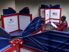FILE - Cornelius Whiting fills out his ballot at an early voting location in Alexandria, Va., on Sept. 26, 2022. Voters in both northern and southwest Virginia have recently received notices directing them to incorrect polling locations, the state Department of Elections confirmed this week.