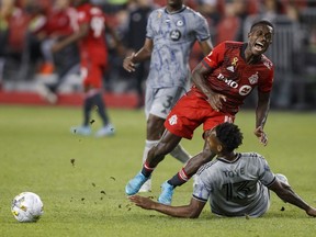 Toronto FC defender Richie Laryea (19) collides with CF Montreal forward Mason Toye (13) during second half of MLS soccer in Toronto on Sunday, Sept. 4, 2022. Toronto FC holds no love for CF Montreal. But it can do its biggest rival a huge solid Sunday as MLS wraps up the regular season.