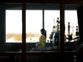 A nurse looks outside while in the intensive care unit at the Humber River Hospital in Toronto on Tuesday, January 25, 2022. Ontario's nursing college can now start allowing internationally educated nurses to practice while they work toward full registration.