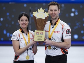 Team Einarson/Gushue skip Kerri Einarson, left, and third Brad Gushue pose with the trophy after defeating Team Sahaidak/Lott at the Canadian Mixed Doubles Curling Championship final in Calgary, Alta., Thursday, March 25, 2021. Gushue and Kerri Einarson face some nontraditional opponents in the inaugural Pan Continental championship starting Monday in Calgary.