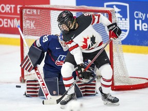 Jessie Eldridge of Canada in action with goalkeeper Nicole Hensley of USA during the IIHF World Championship Woman's ice hockey gold medal match between USA and Canada in Herning, Denmark, Sunday, Sept. 4, 2022. Canada and the U.S will meet in a women's hockey Rivalry Series game Dec. 15 in Henderson, Nev.