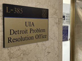 Light shines through the entrance of a Michigan unemployment office in Detroit, Thursday, Oct. 20, 2022. State lawmakers agreed to spend $20 million to settle lawsuits by thousands of people who were wrongly accused of fraud when they sought unemployment benefits. They were tripped by a bad computer system.