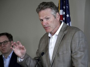 FILE - Alaska Gov. Mike Dunleavy, right, speaks during a news conference during a broadband summit in Anchorage, Alaska, Tuesday, Aug. 9, 2022. An investigation into a complaint alleging improper coordination between Dunleavy's campaign and a third-party group that supports his reelection is not expected to be completed before the Nov. 8 election.