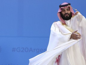 FILE - Saudi Arabia's Crown Prince Mohammed bin Salman adjusts his robe as leaders gather for the group at the G20 Leader's Summit at the Costa Salguero Center in Buenos Aires, Argentina, Nov. 30, 2018. Saudi Arabia's powerful 37-year-old crown prince will not attend an upcoming summit in Algeria after his doctors advised him not to travel, the Algerian presidency said early Sunday, Oct. 23, 2022.