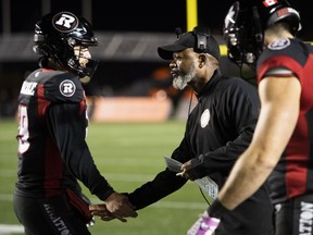Ottawa Redblacks interim head coach Bob Dyce congratulates quarterback Nick Arbuckle (19) after a touchdown against the Montreal Alouettes during first half CFL football action in Ottawa on Oct. 14, 2022. After three straight seasons of falling far short of expectations, Redblacks general manager Shawn Burke will have his work cut out for him this off-season. Ottawa finished the 2022 season 4-14-0.