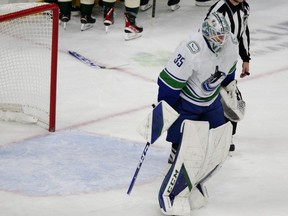 Vancouver Canucks goaltender Thatcher Demko skates off after breaking his stick following the team's overtime loss to the Minnesota Wild in an NHL hockey game Thursday, Oct. 20, 2022, in St. Paul, Minn. On their season-opening road swing, the Canucks became the first team in NHL history to lose their first four games of the season while blowing multi-goal leads, and after five straight losses (0-3-2), Vancouver is the only team in the league that has yet to record a win.