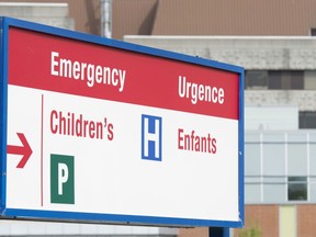 A sign directing visitors to the emergency department is shown at the Children's Hospital of Eastern Ontario, Friday, May 15, 2015 in Ottawa. CHEO has advised families of long wait times at its emergency department amid high occupancy rates and staff shortages that have led to cancelled surgeries and other procedures.
