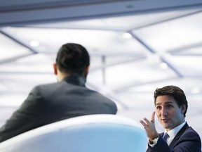 Prime Minister Justin Trudeau participates in a Q-and-A at a net-zero conference in Ottawa on Tuesday, Oct. 18, 2022. Trudeau says he will guarantee that Canada will in fact meet its latest emissions target.