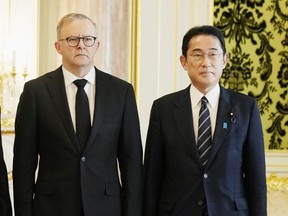 FILE - Australian Anthony Albanese, left, poses for a photo with Japanese Prime Minister Fumio Kishida before their meeting at the Akasaka Palace state guest house in Tokyo on Sept. 27, 2022. Albanese said Wednesday, Oct. 19, he will discuss with his Japanese counterpart Fumio Kishida strengthening their bilateral defense and security partnership to counter a more assertive China when the leaders meet in Australia this week.