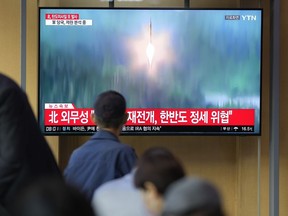 FILE - A TV screen showing a news program reporting about North Korea's missile launch with file footage, is seen at the Seoul Railway Station in Seoul, South Korea on Oct. 6, 2022. The nuclear-powered aircraft carrier USS Ronald Reagan launched a new round of naval drills with South Korean warships on Friday, a day after North Korea fired more ballistic missiles and flew warplanes in an escalation of its weapons tests.
