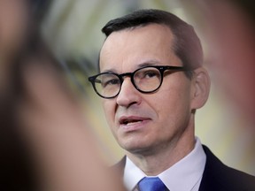 FILE - Poland's Prime Minister Mateusz Morawiecki speaks with the media as he arrives for an EU summit in Brussels on Oct. 21, 2022. Morawiecki said late Friday, Oct. 28, 2022 that Poland's nuclear energy project will use the "reliable, safe technology" of Westinghouse Electric Company, saying a strong Poland-U.S. alliance "guarantees the success of our joint initiatives."