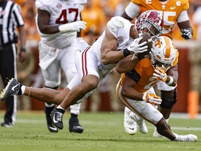 Alabama linebacker Henry To'oTo'o (10) tries to make an interception of a pass intended for Tennessee running back Jabari Small (2) during the first half of an NCAA college football game Saturday, Oct. 15, 2022, in Knoxville, Tenn.